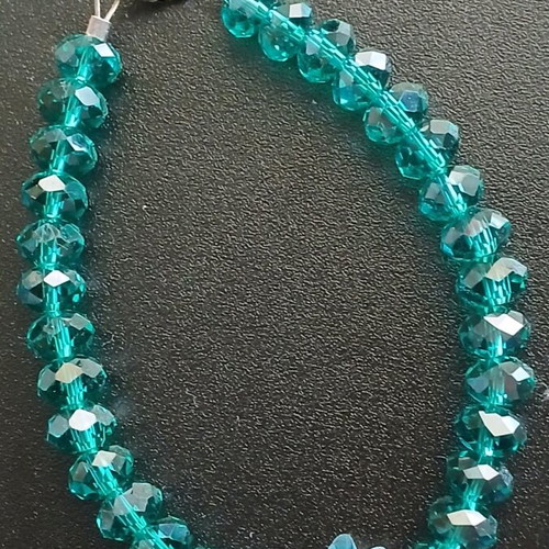 Bracelet with crystal beads used, emerald/petrol color with fish motif