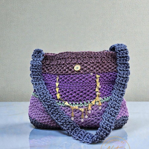 Handmade knitted shoulder bag in purple shades with gold details
