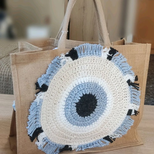 Jute bag with knitted decorative eye and waterproof lining