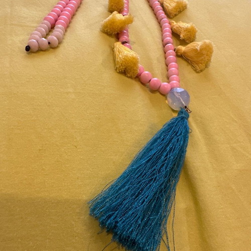 Long necklace with pink stones and evil eyes used, yellow and petrol tassels