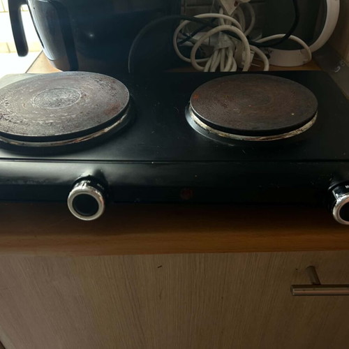 Electric tabletop stove with two burners used