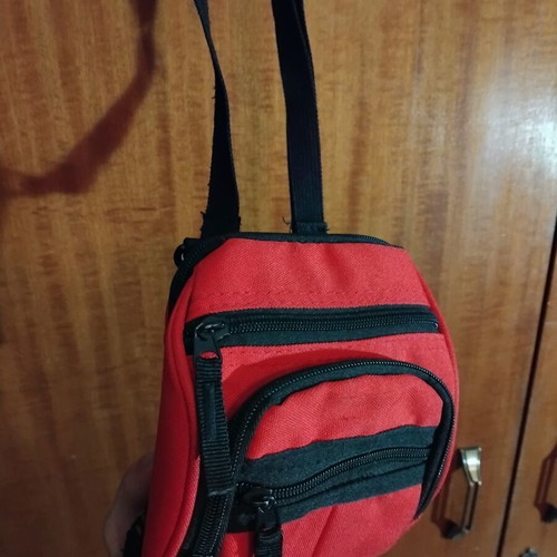 Small red shoulder bag used with multiple compartments