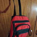 Small red shoulder bag used with multiple compartments