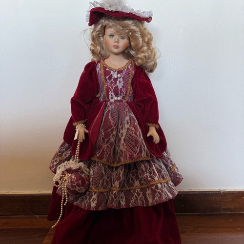Porcelain doll with burgundy velvet dress like new