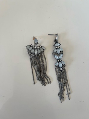 Earrings used with white stones different on each ear