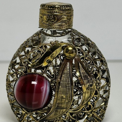 Vintage perfume flacon with filigree metalwork and red cabochon