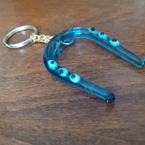 Glass horseshoe keychain used with blue evil eyes