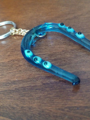 Glass horseshoe keychain used with blue evil eyes