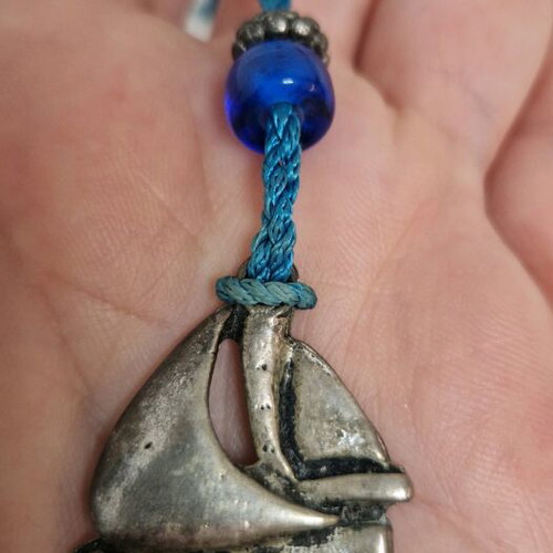 Gouri boat from Mati with blue bead like new