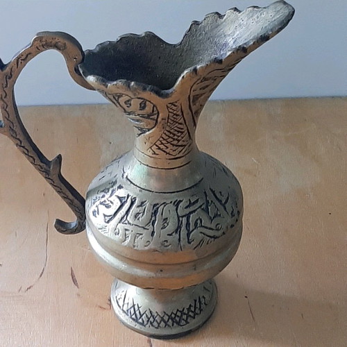 Oriental solid brass pitcher used with saucer