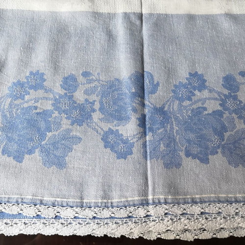 Aegean blue cotton tablecloth with floral woven patterns and lace trim