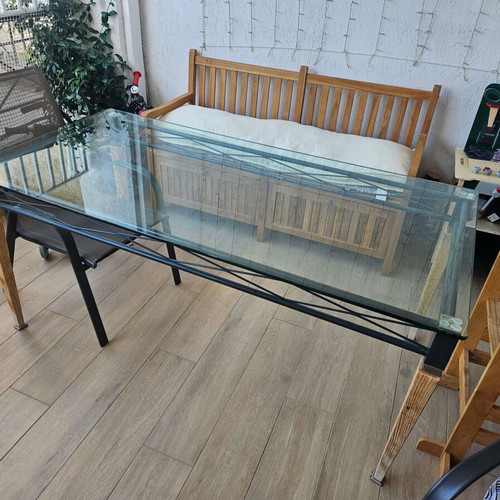 Garden table used with wooden legs, metal base and glass top