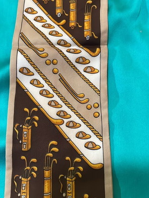 Long scarf like new with golf designs in beige and brown