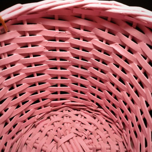 Decorative pink rattan basket with gold handles, handmade