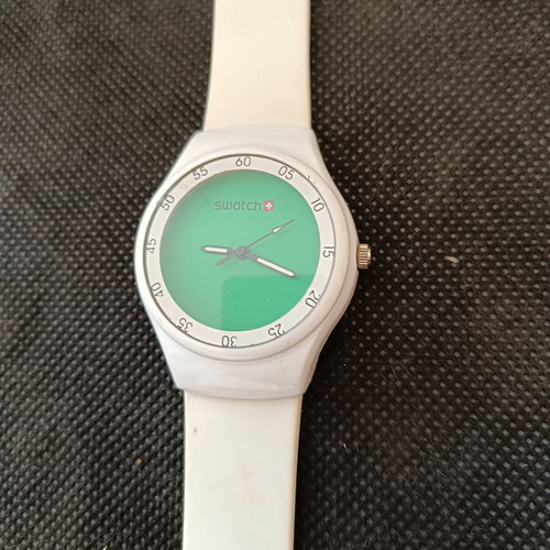 Swatch watch used with white silicone strap and green dial