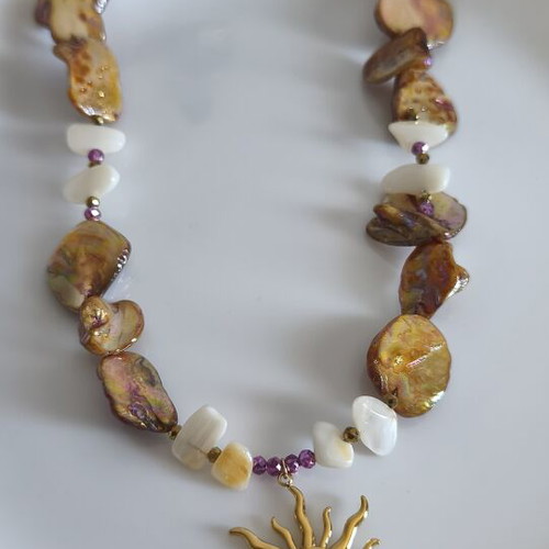 Necklace with mother of pearl and gold steel sun pendant