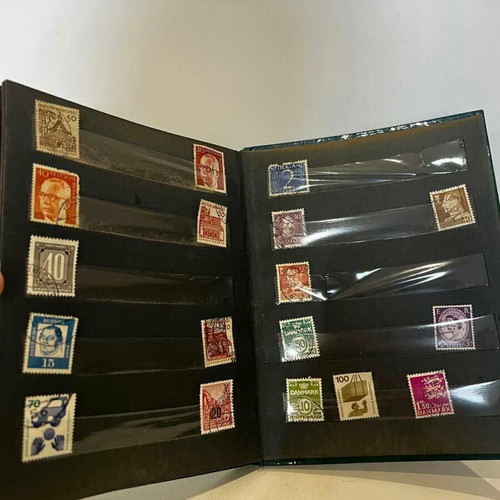 Stamp album with various collectible stamps used, 19x14.5 cm