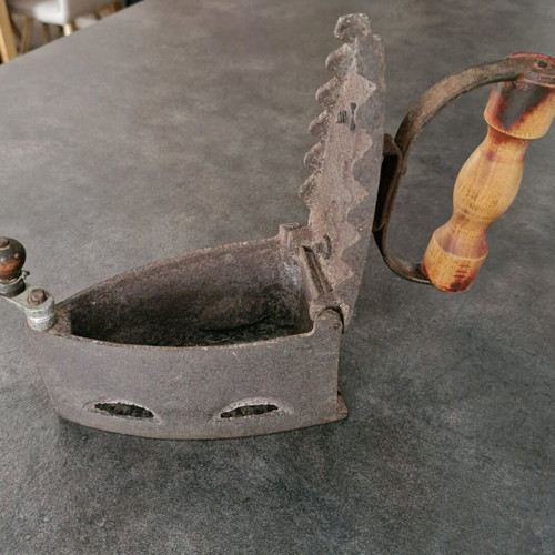 Vintage coal iron used with wooden handle and patina