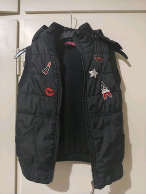 Black sleeveless jacket (vest) with hood and embroidered designs used, age 7-8