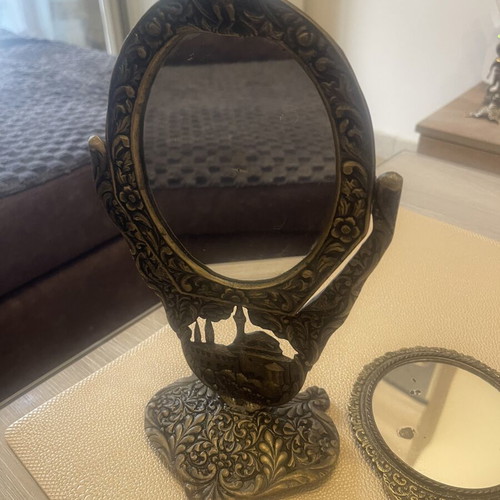 Set of two brass mirrors, table and hand used