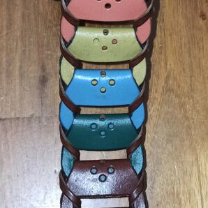 Colorful woven belt in warm shades made of faux leather, like new