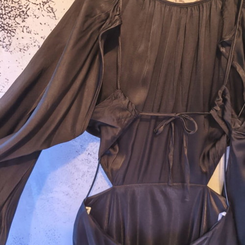 Black mini dress used with open back and bell sleeves, size S