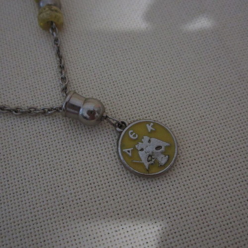 Vintage knotted AEK komboloi used with metal emblem