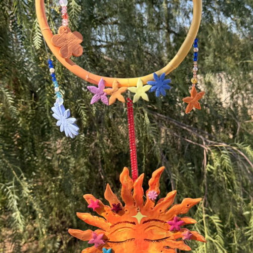 Handmade clay mobile with sun and flowers