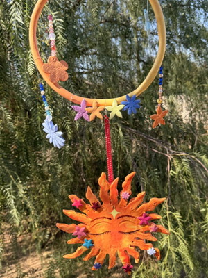 Handmade clay mobile with sun and flowers
