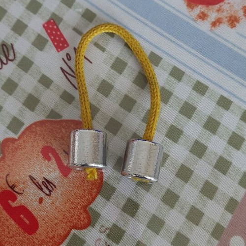 Metal worry beads used with yellow cord