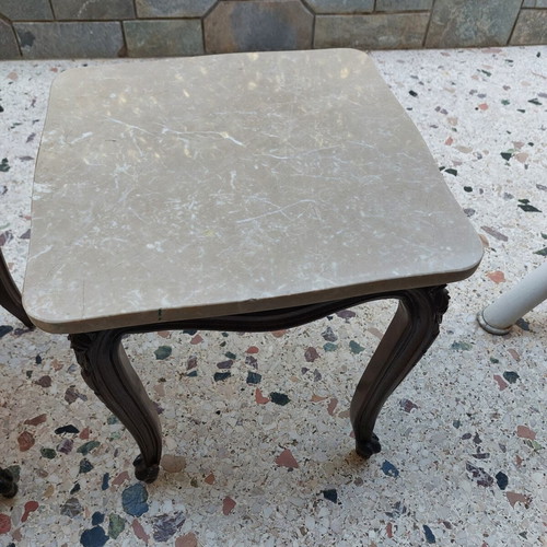 Vintage side tables pair with natural marble used