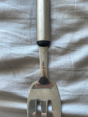Hoffritz serving fork like new, stainless steel with plastic handle