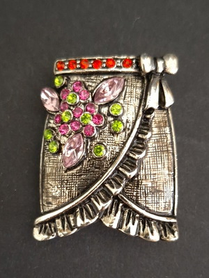 Vintage skirt-shaped brooch in silver metal with colorful rhinestones like new