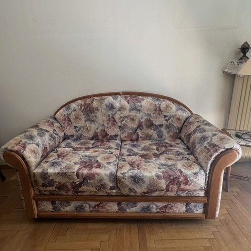 Living room sofa set with curved wooden frame and floral upholstery
