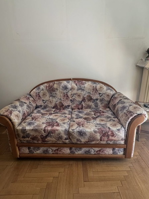 Living room sofa set with curved wooden frame and floral upholstery