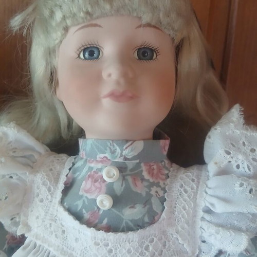 Porcelain doll like new with vintage lace dress and floral details