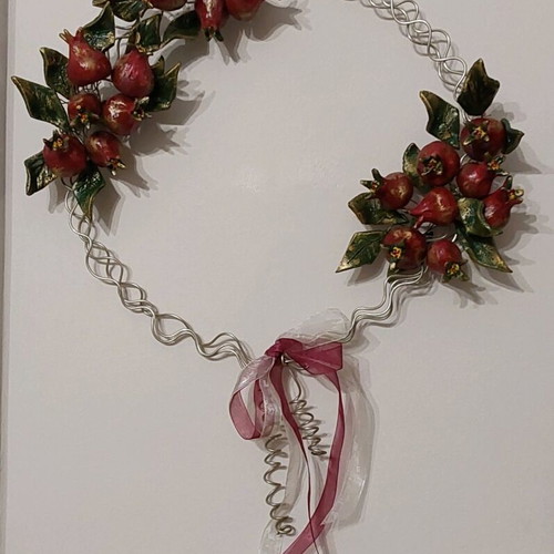 Handmade metal and clay wreath with pomegranates