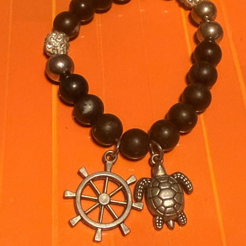Elastic bracelet like new with steering wheel and turtle charms black-silver