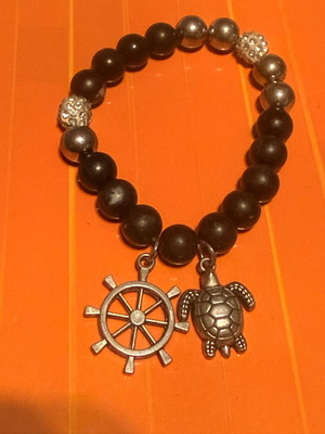 Elastic bracelet like new with steering wheel and turtle charms black-silver