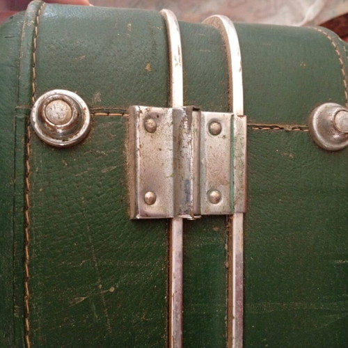 Vintage suitcase used with dark green color and quilted lining