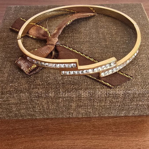 Steel bracelet in rose gold color with decorative stones, like new