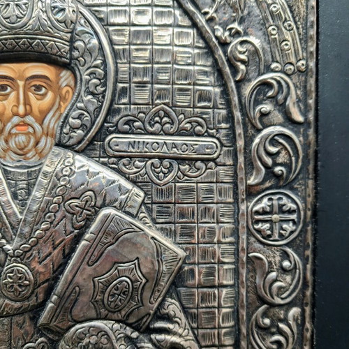 Silver embossed icon of Saint Nicholas used, with wooden base