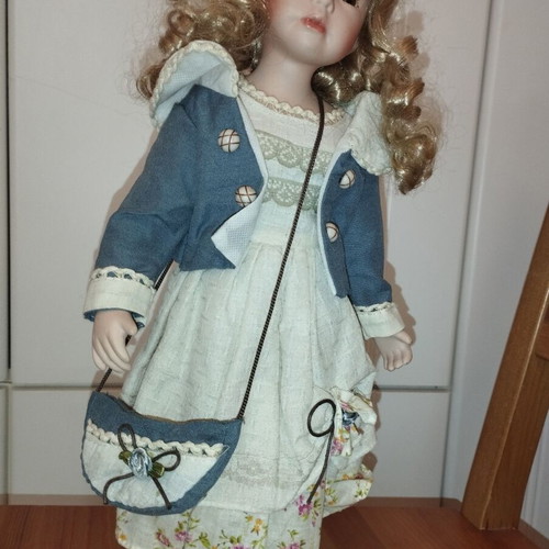Porcelain doll rare, new with hat and dress