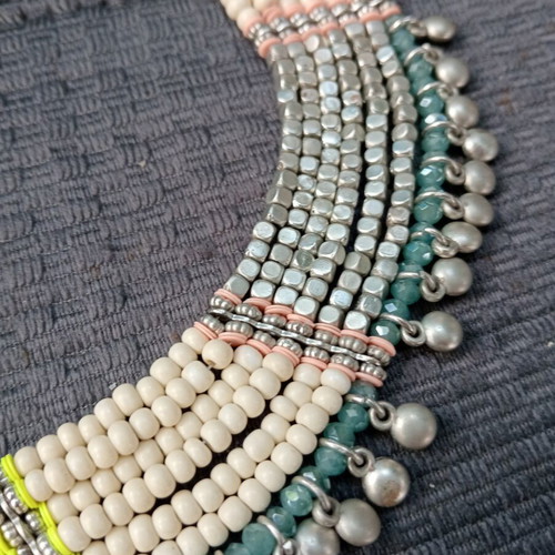 Accessorize multistrand necklace with plastic and glass beads
