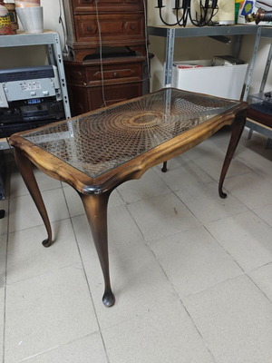 Vintage brown baroque coffee table with glass top and rattan weave used