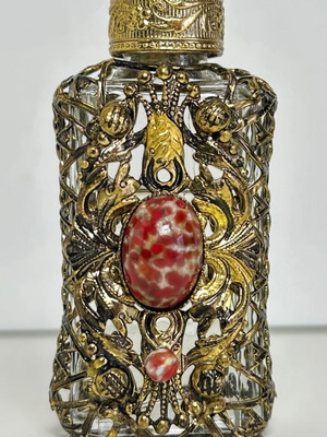 Vintage perfume flacon with filigree metalwork and red cabochon