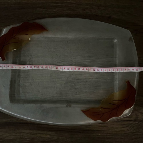 Decorative glass tray used with embossed leaf design