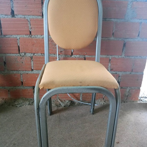 Metal chairs used with yellow cushions, silver frame