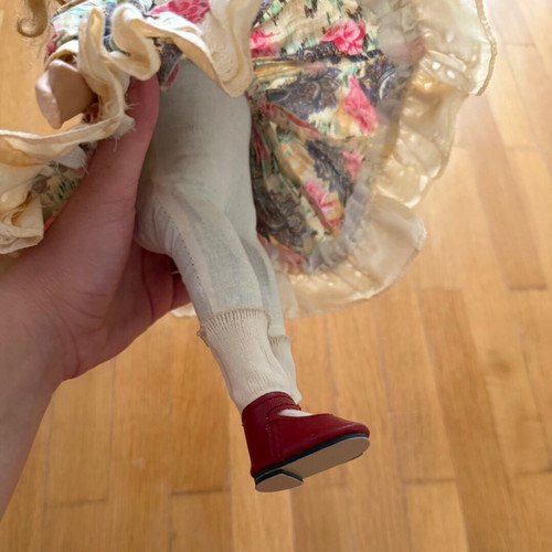 Porcelain doll like new with colorful dress and straw hat