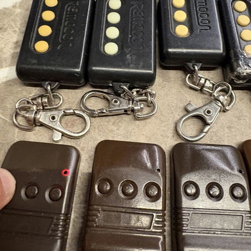 Garage door remotes used, set of 10, one broken with tape